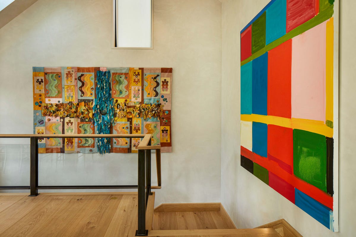Telluride stairwell with Tau Lewis Return of the Martian Water God and Stanley Whitney painting