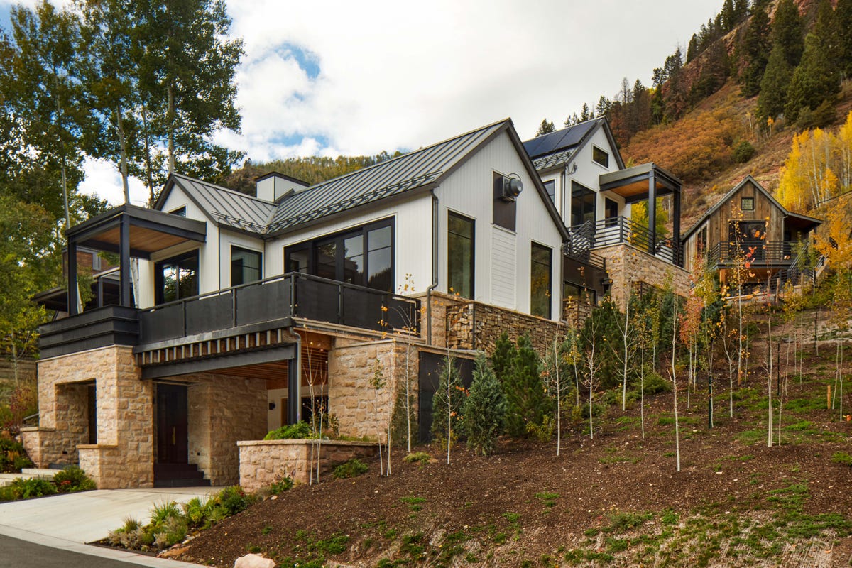 Exterior of Becky Gochman’s Telluride mountain home among autumn aspens