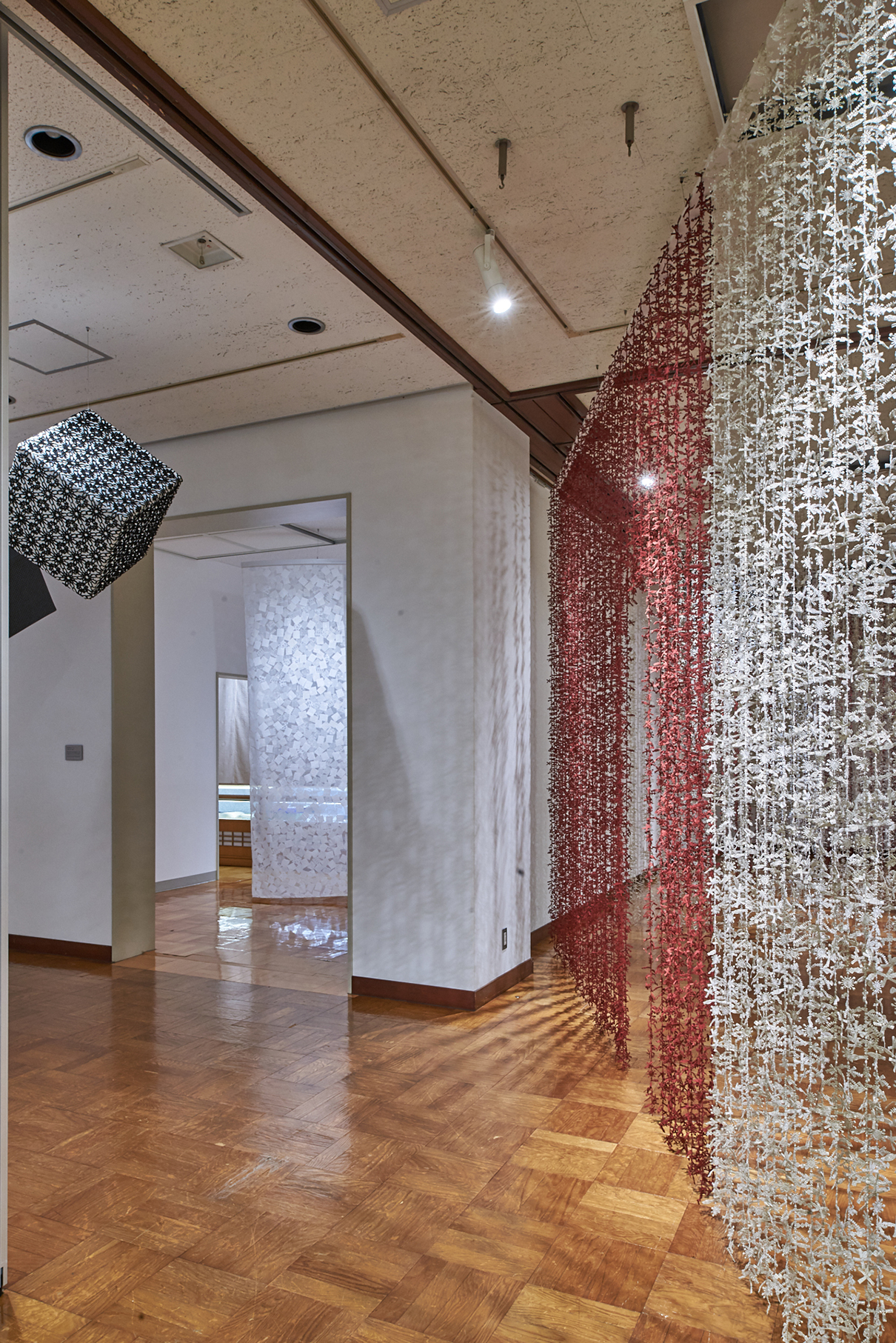Installation view of suspended and layered NUNO textiles, Misato Town Alumni Museum, 2023. Photo: Masayuki Hayashi; courtesy NUNO.