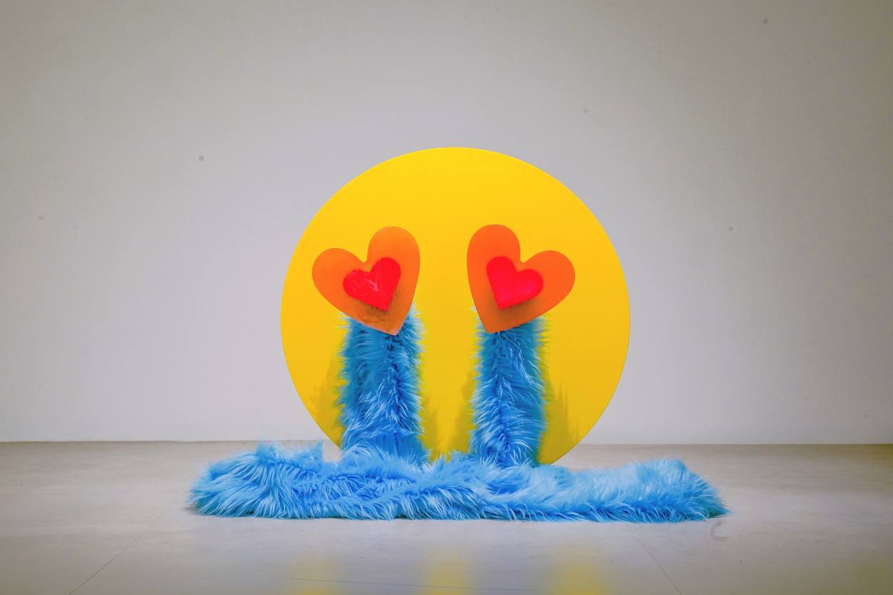 Yelin Lee (Yelin-ment), Crying Smiling Face with Heart-Eyes, 2026. MDF, resin, fabric and aluminium, 78 × 78 cm.