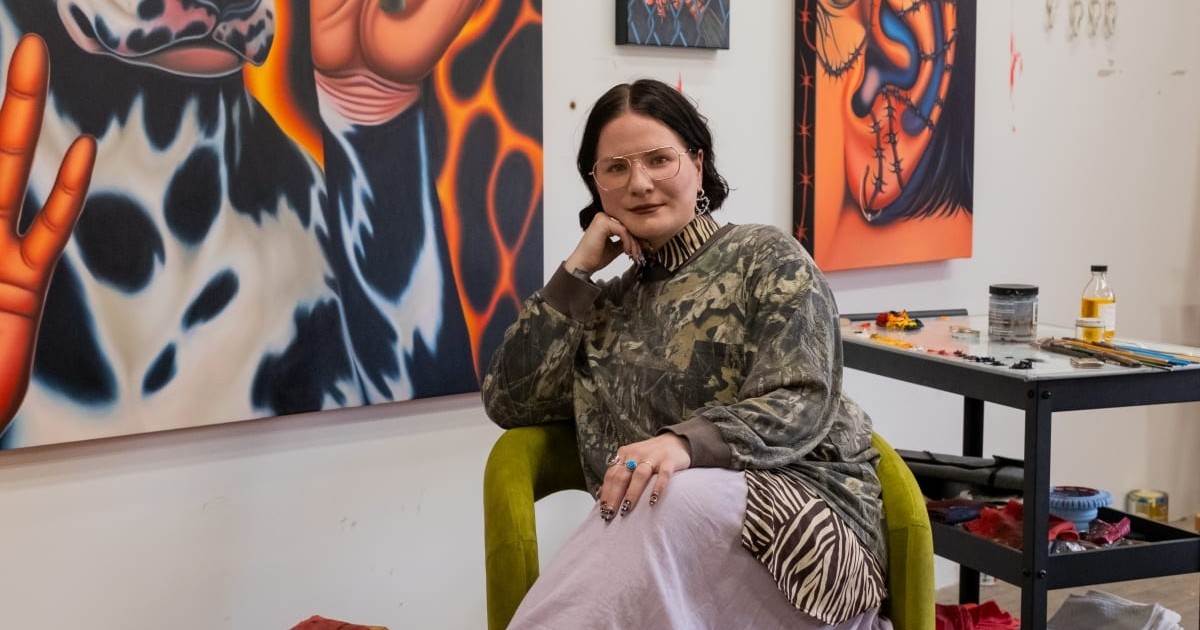 Artist Madeline Brice in her studio surrounded by paintings