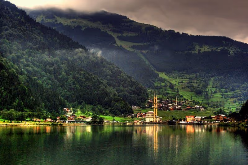 Structures reflecting lights on the water on the shore of Uzungol