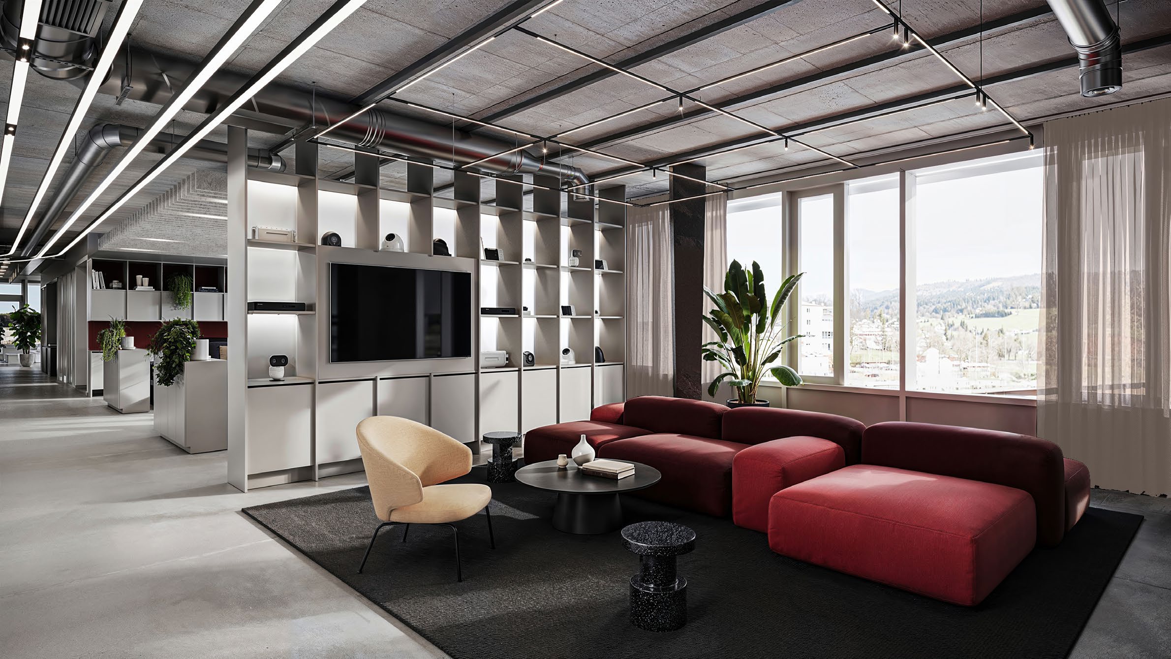 Unispace design rendering of the NKT Photonics entrance lounge, with burgundy seating beside large windows.