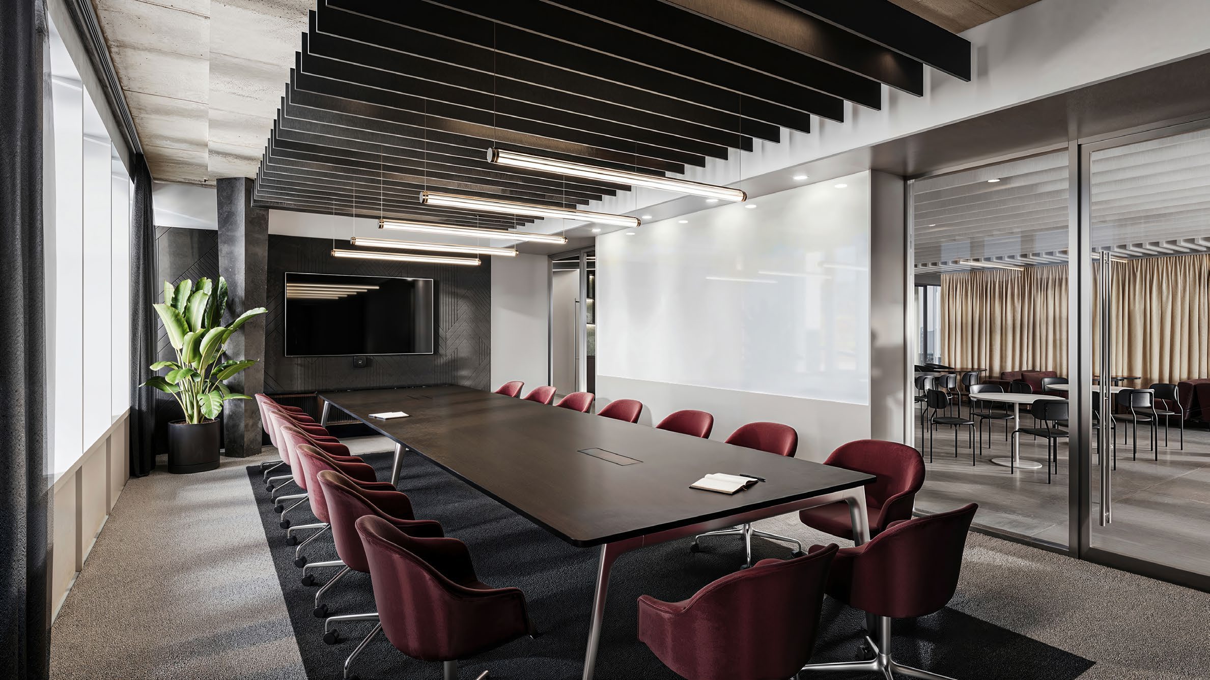 Unispace design rendering of the NKT Photonics boardroom, showing a long table, burgundy chairs and glazed partitions.