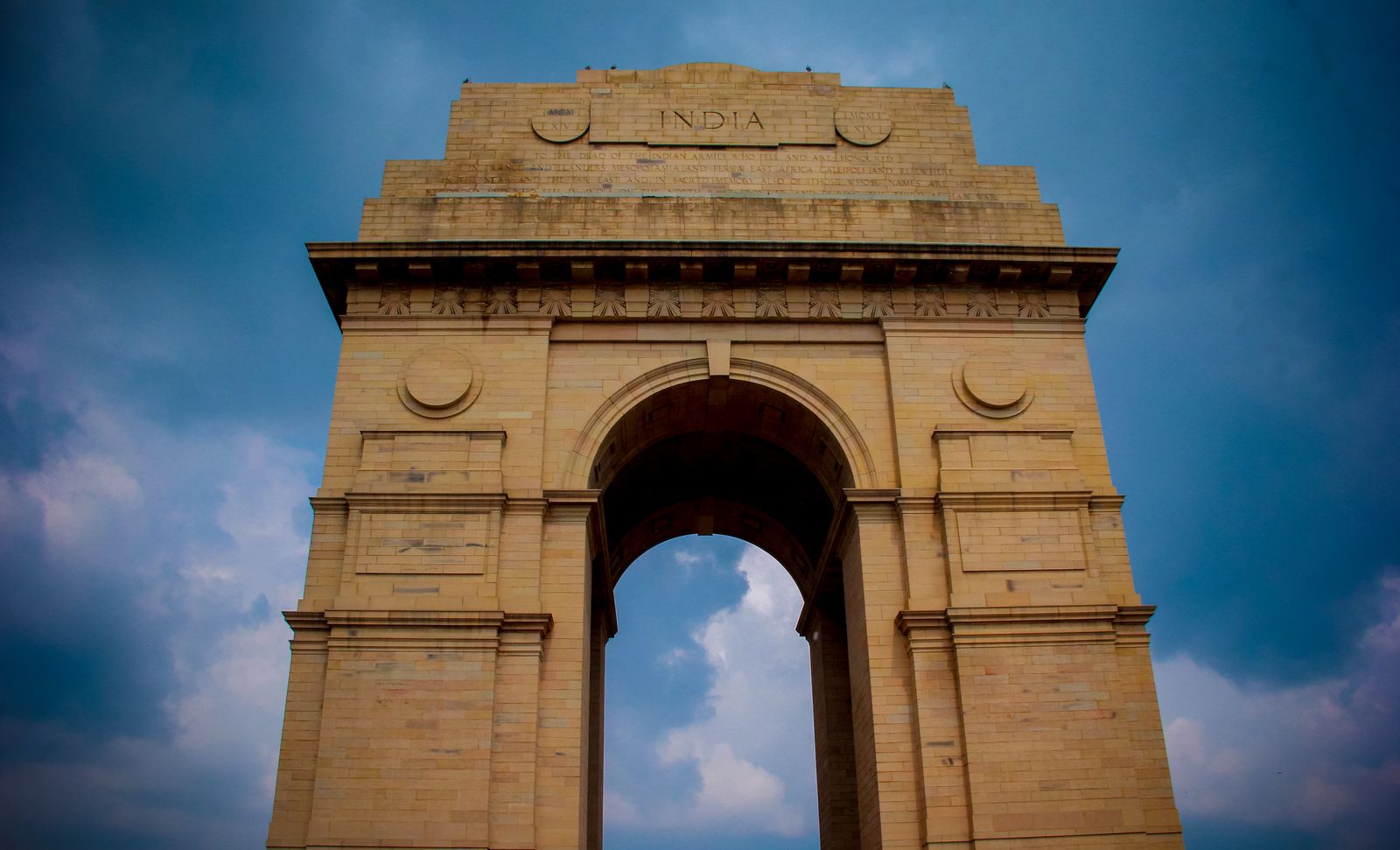 India Gate in New Delhi under a blue sky. Photo by Asif Methar on Pexels.