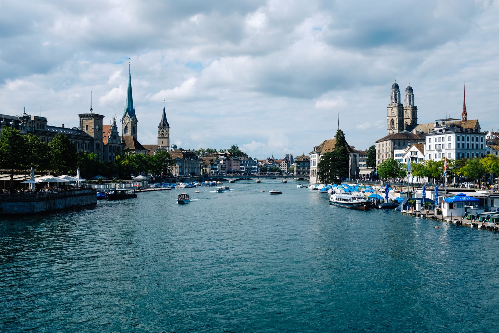 Zurich waterfront buildings and historic towers along the Limmat River. Photo by Adrien Olichon on Pexels.