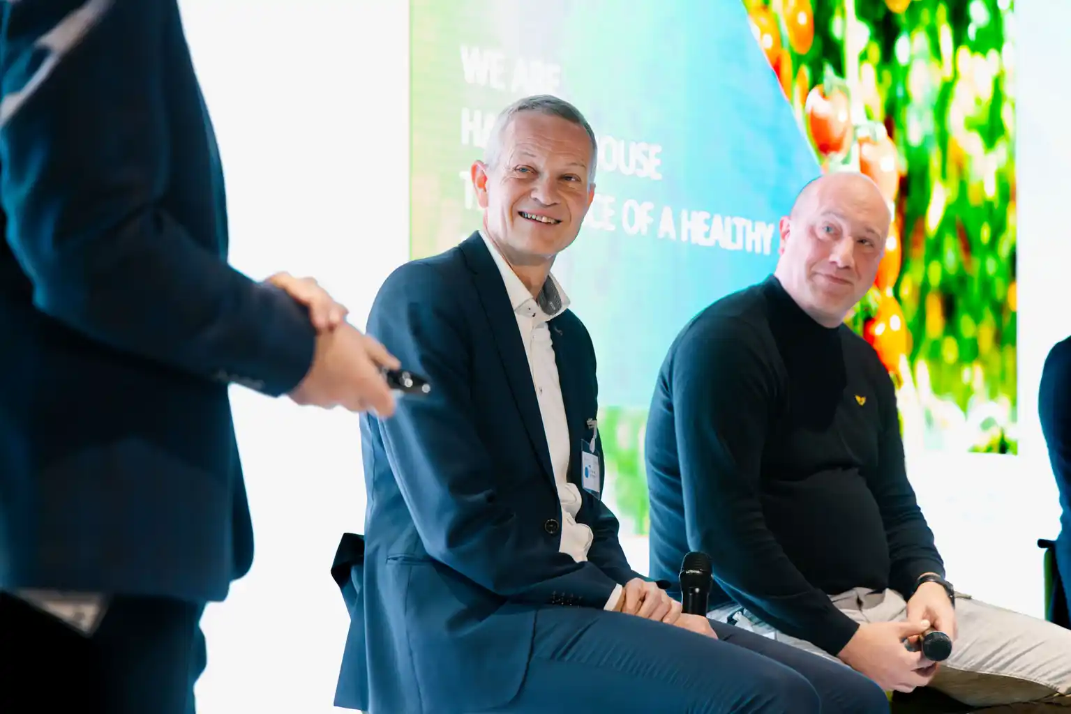 Panel participants listening during an on-stage discussion