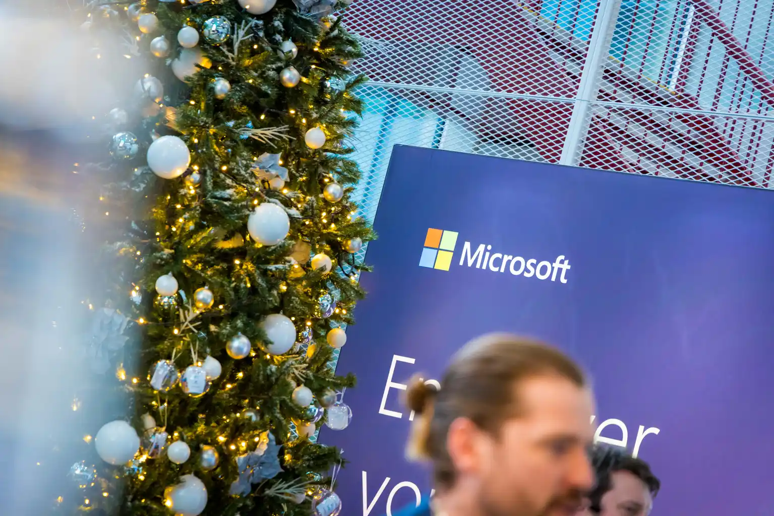 Microsoft event branding beside a decorated tree at the venue