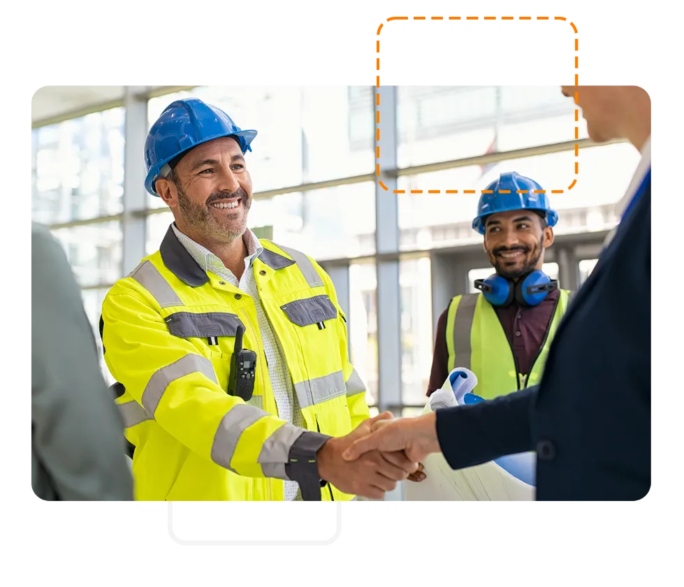 Site manager wearing construction helmet shaking hands with investor on site