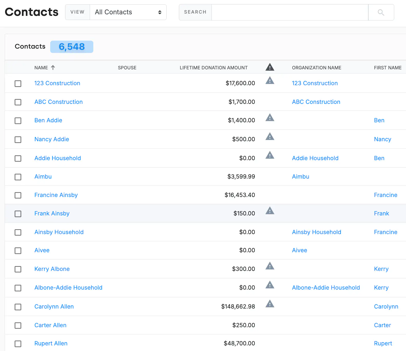 A DonorDock contacts list where household records such as Addie Household and Ainsby Household appear alongside the individual contacts who belong to them, each individual keeping their own lifetime donation amount.