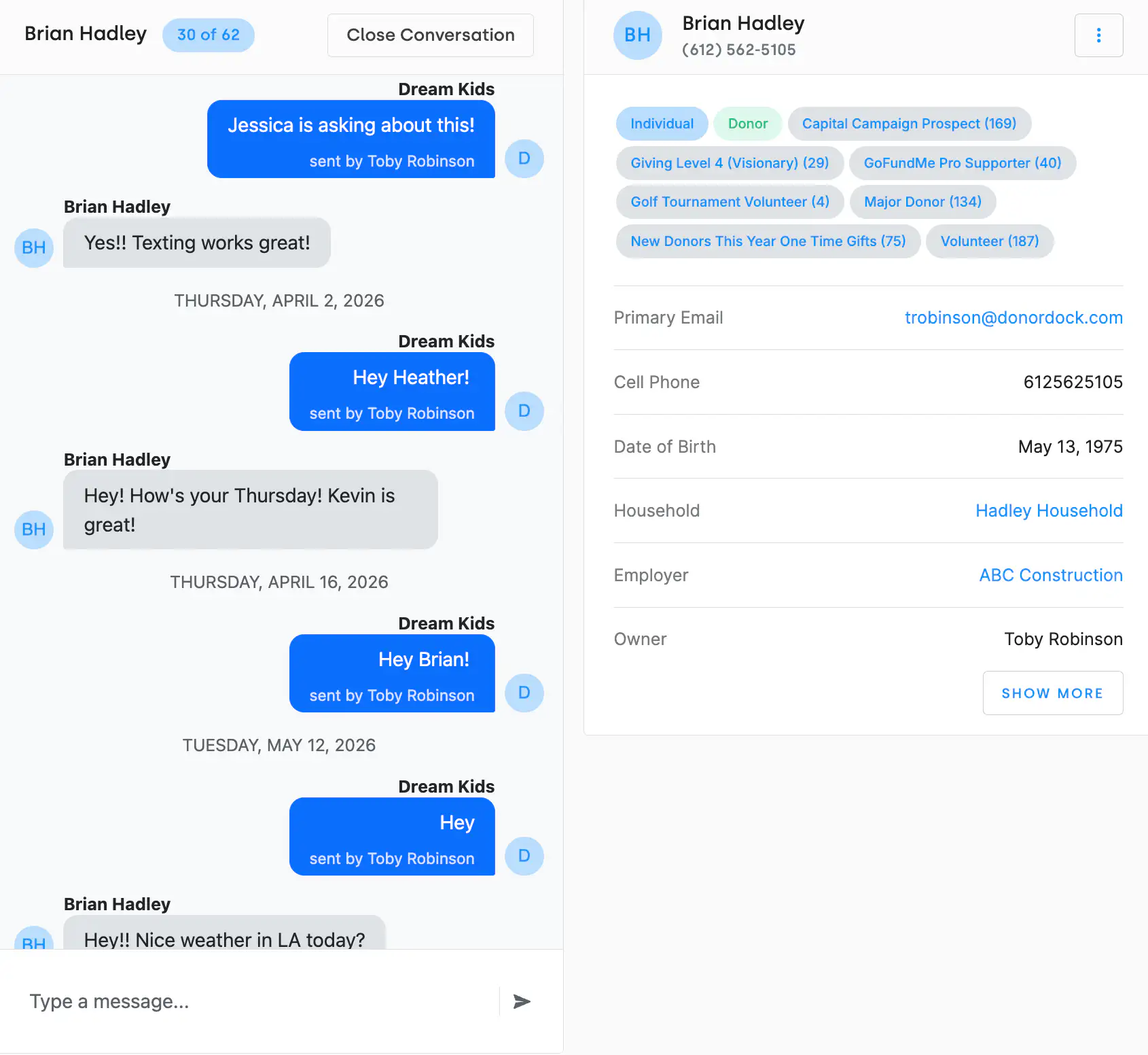 The DonorDock Text Conversations screen: an inbox of open conversations on the left, the message thread in the middle with the organization's blue outgoing message, and the contact's summary card on the right showing badges, email, cell phone, household, and owner.