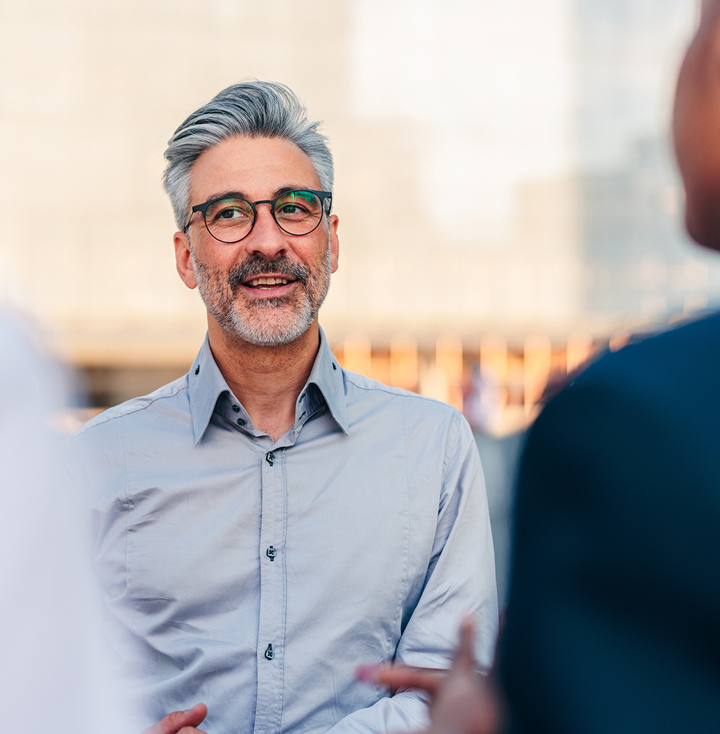 A Wynford strata manager in conversation with a colleague outside a city building.