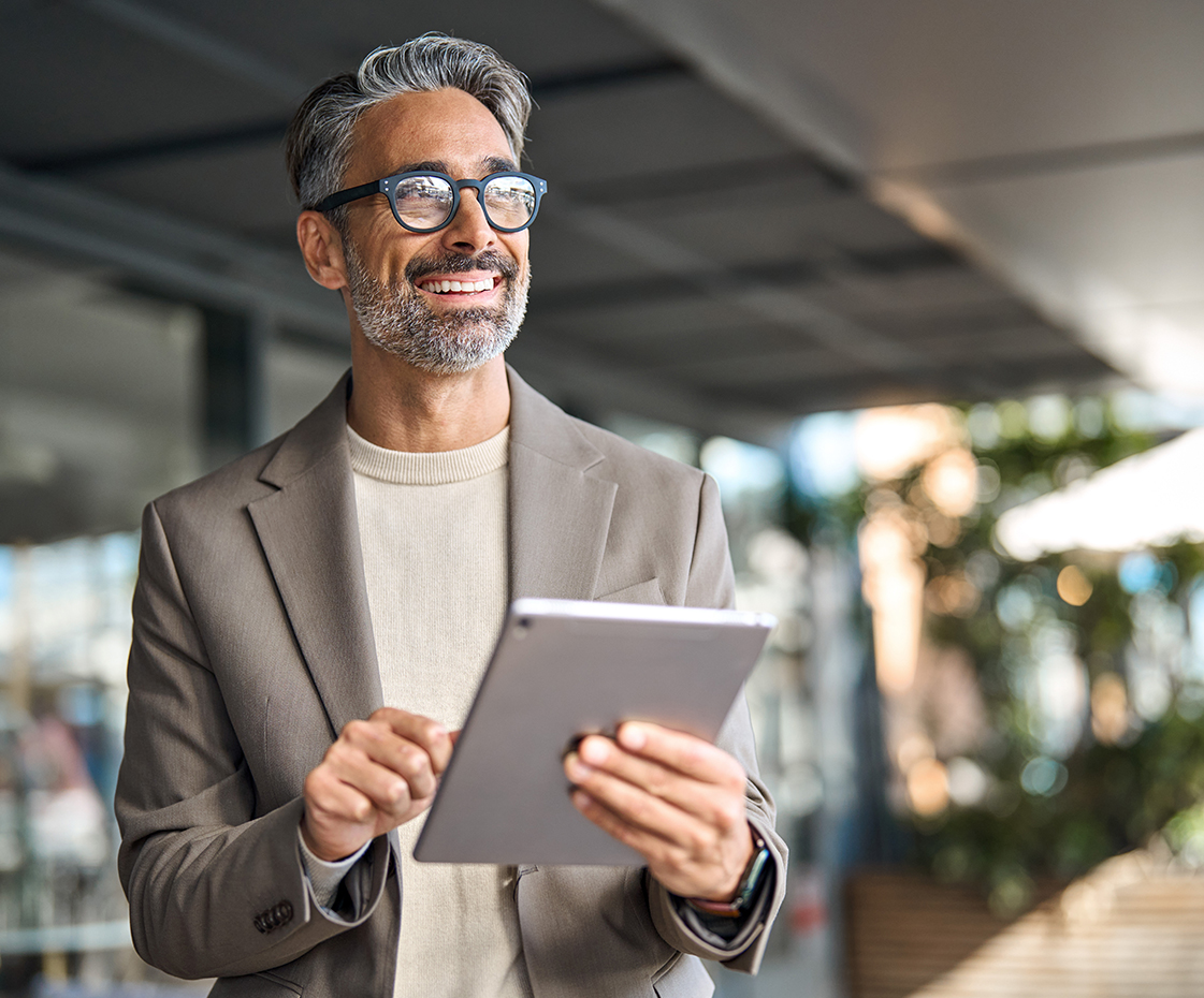 A Wynford strata manager holding a tablet in a bright modern building.
