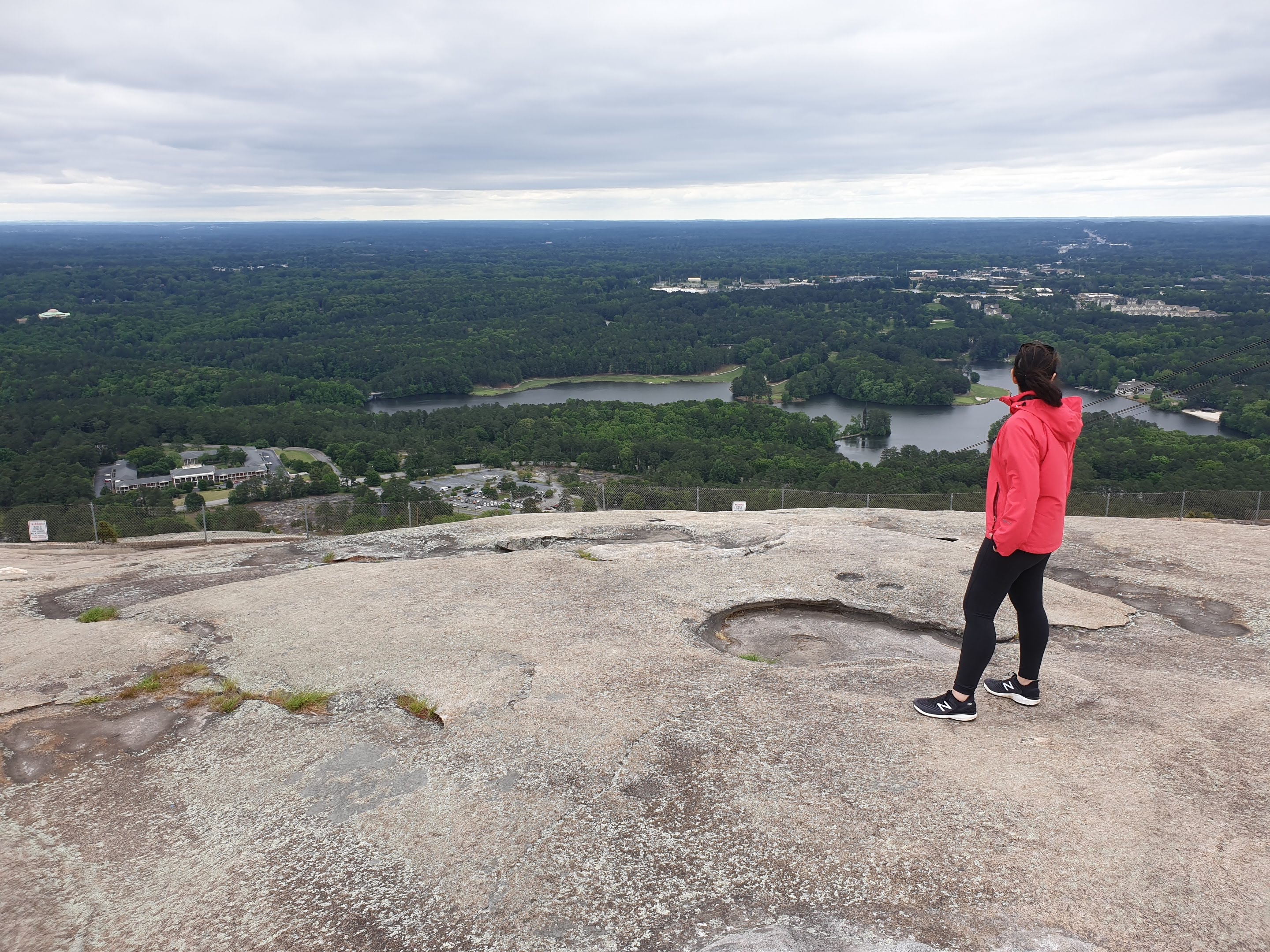 Me admiring the vastness of the land beyond, after having climbed to the top of Stone Mountain in USA.
