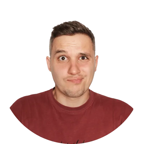 A person with short, dark hair wearing a maroon t-shirt stands against a plain black background.