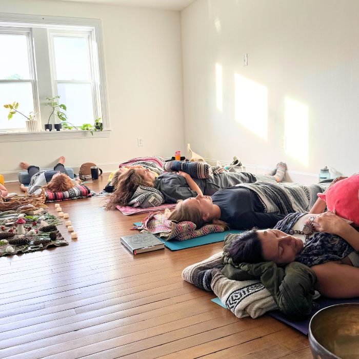 participants lying down during sound bath on yoga mats with yoga blankets