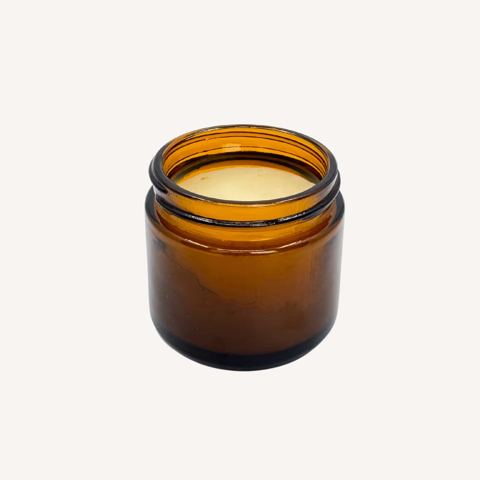 All Tree Roots Soother Salve in an open 2 oz amber glass jar, a natural herbal salve for sore muscles and joint tension