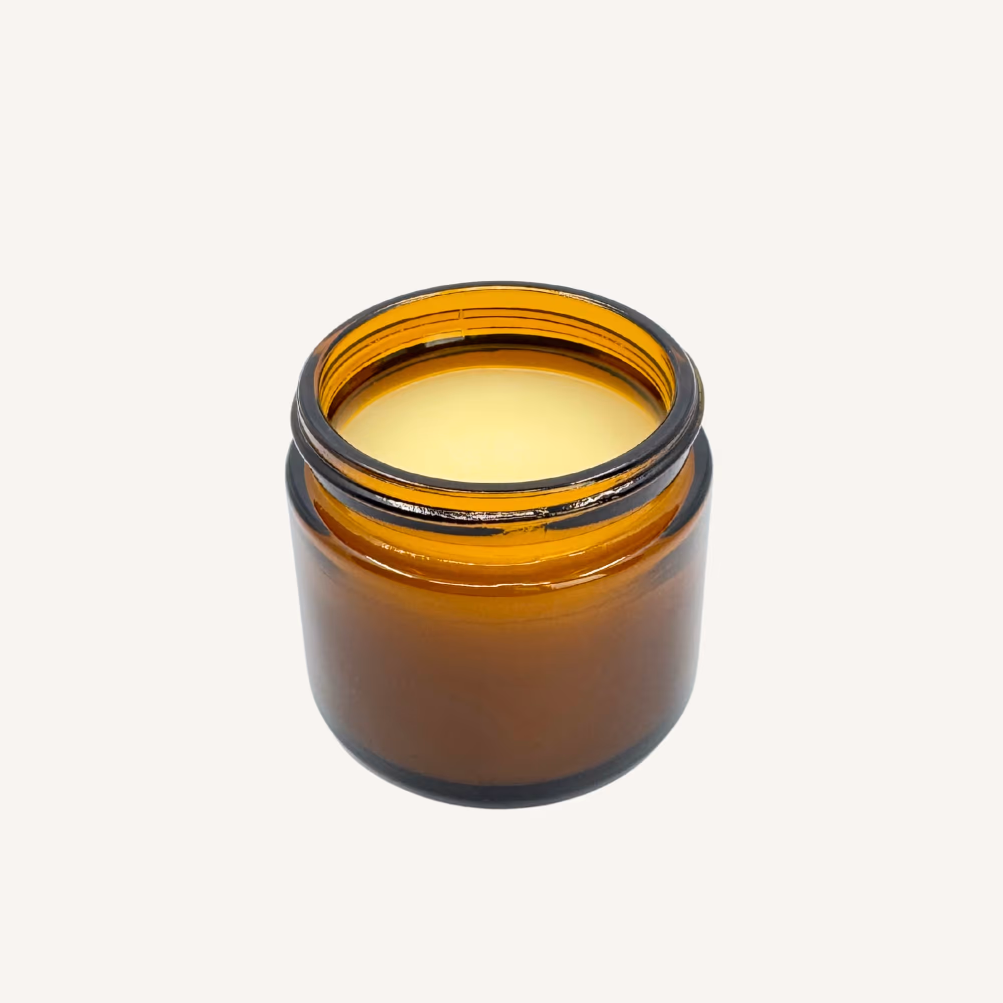 1 oz amber glass jar of All Tree Roots Cacao Face Cream, shown open to highlight its rich, whipped texture.