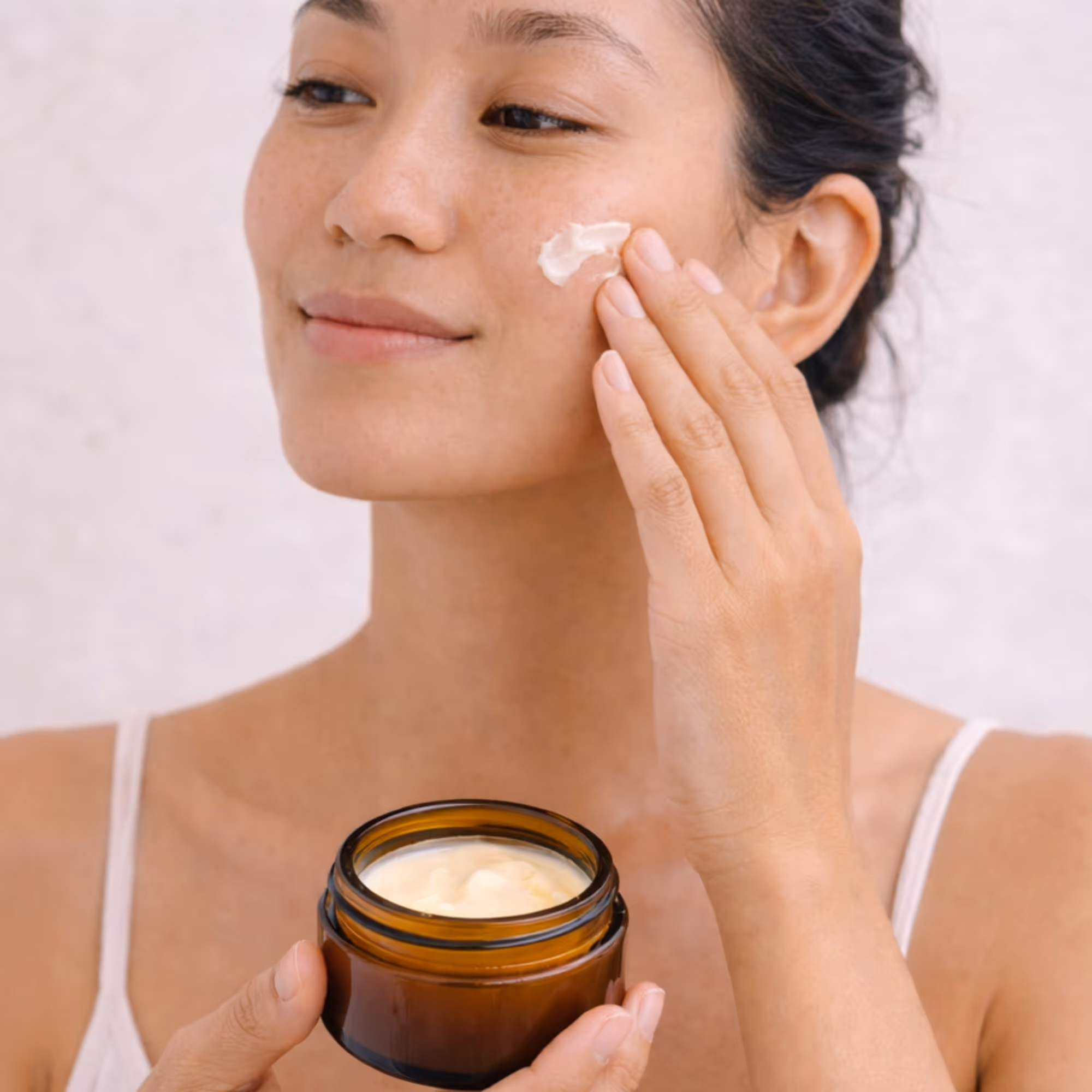 Applying All Tree Roots Cacao Face Cream — daily face moisturizer for dry, dull, or sensitive skin.