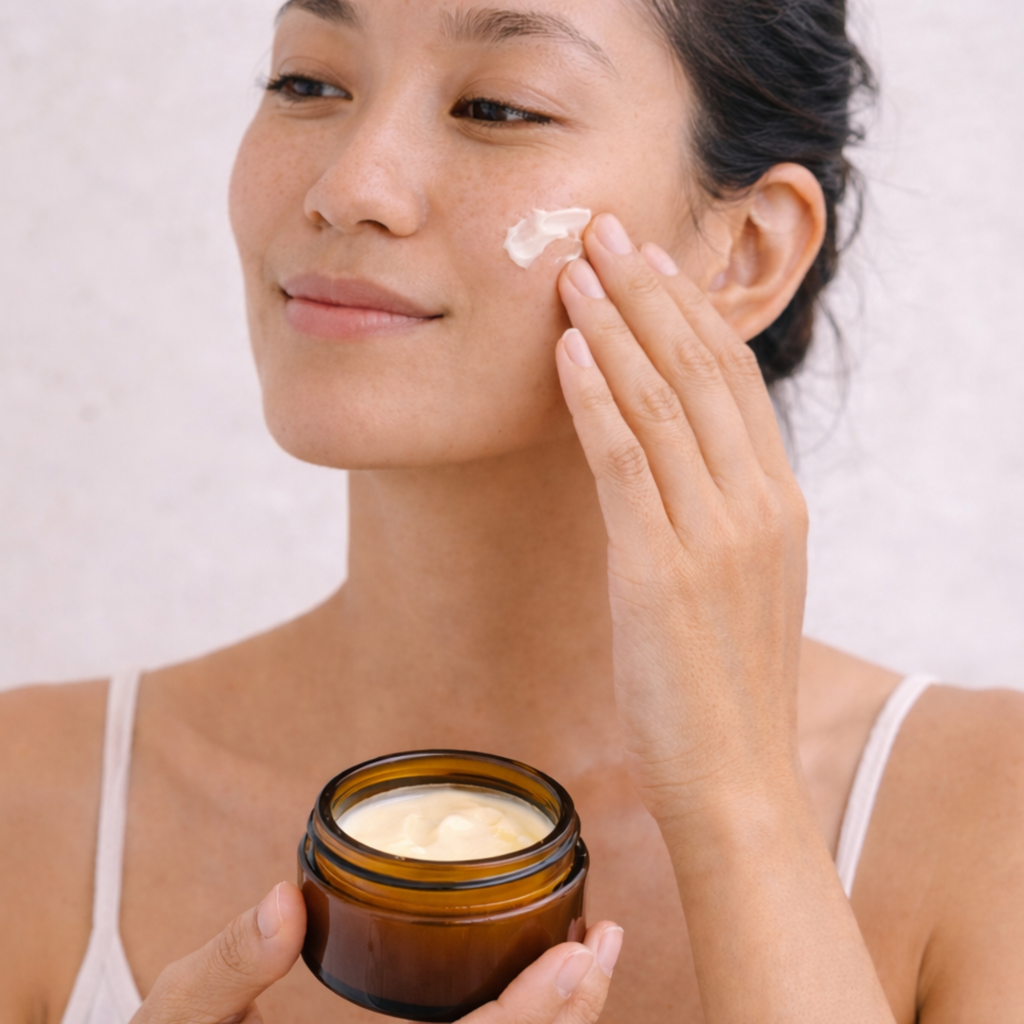 Applying All Tree Roots Cacao Face Cream — daily face moisturizer for dry, dull, or sensitive skin.