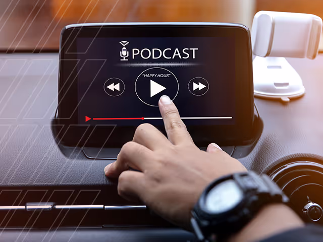Driver selecting podcast on car dashboard