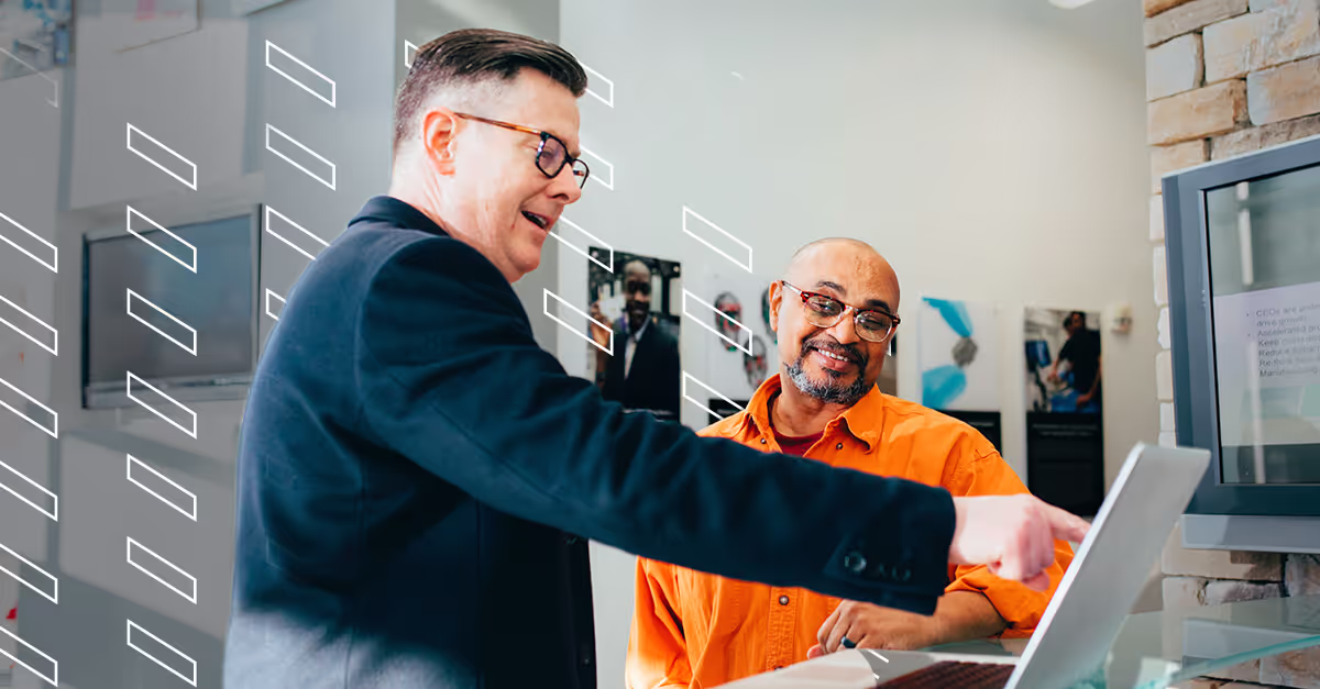 Two men discussing wholesale vehicle pricing strategies