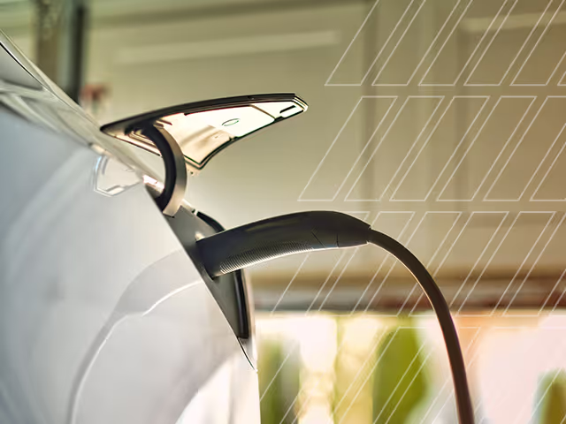 An electric car getting charged in a garage