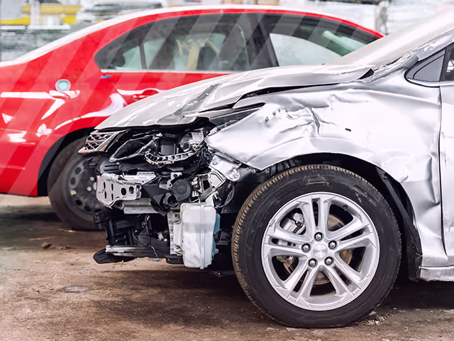 A silver used car with front damage