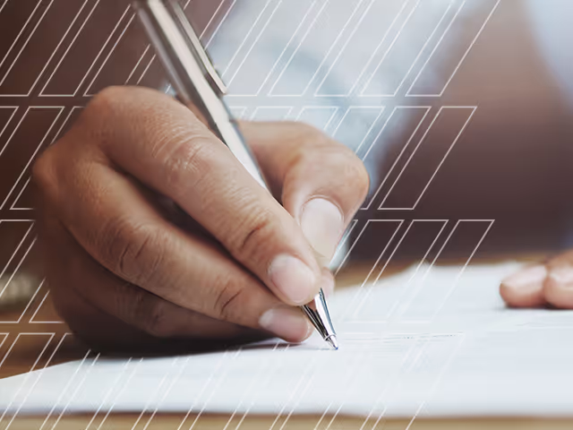 A used car sales person uses a pen to take notes 
