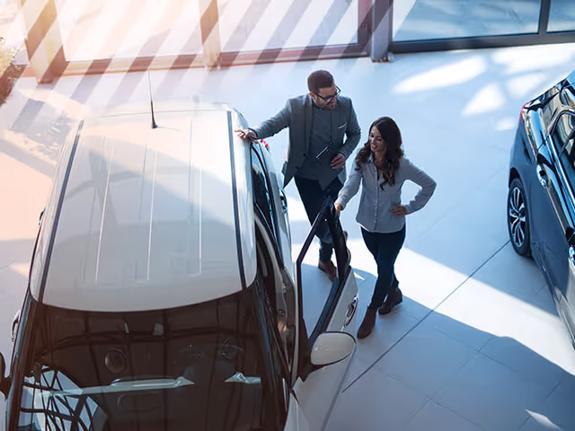 An Auto Broker showing his client a used car