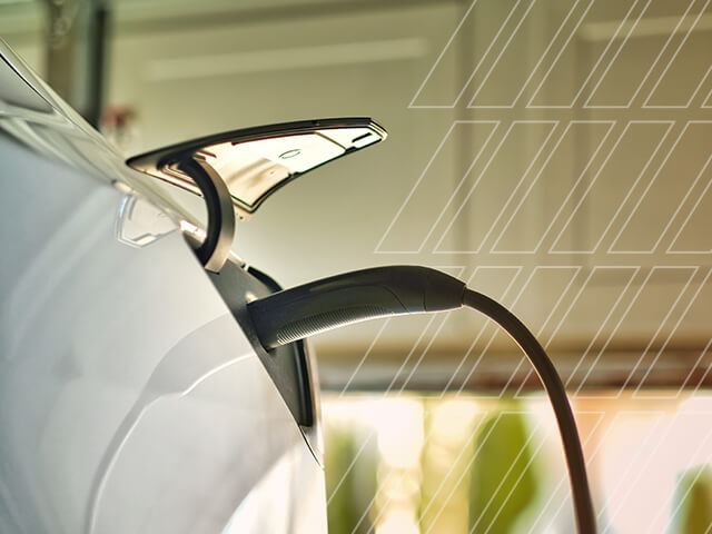 An EV gets charged in a garage