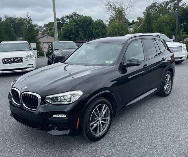 A used black 2018 BMW X3 in a dealer lot