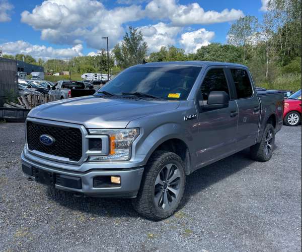 A silver 2020 Ford F150 in a parking lot