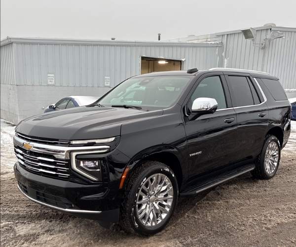 A used black 2025 Chevrolet Tahoe in a parking lot