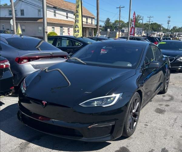 A black used 2025 Tesla Model S in a parking lot