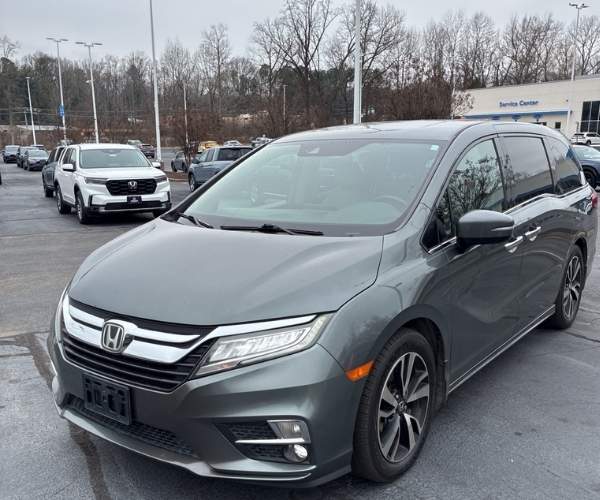 A used 2018 Honda Odyssey in a parking lot.