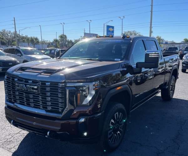 A black GMC Sierra 3500HD in a parking lot