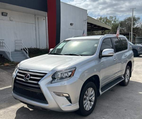 A silver Lexus SUV in dealer lot