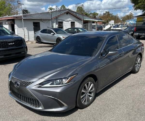 A gray Lexus in a dealer parking lot