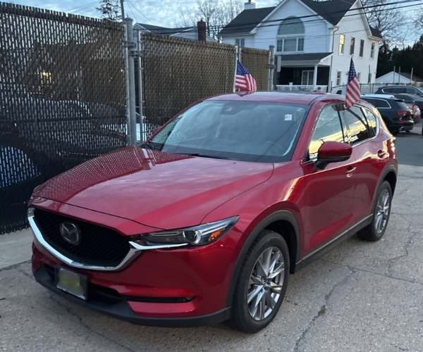 A red 2021 Mazda CX5 in a dealer lot