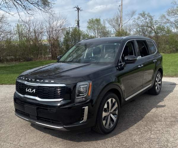 A black 2022 Kia Telluride parked in an empty street