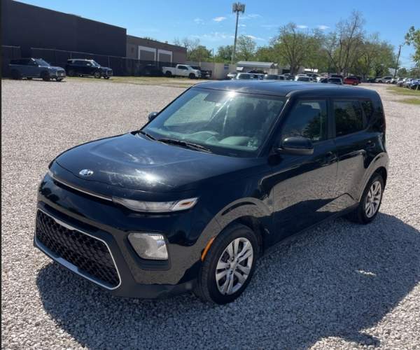 A black 2021 Kia Soul in an empty lot