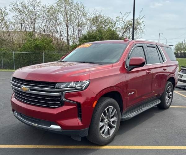 A red 2021 Chevrolet Tahoe in a dealer lot