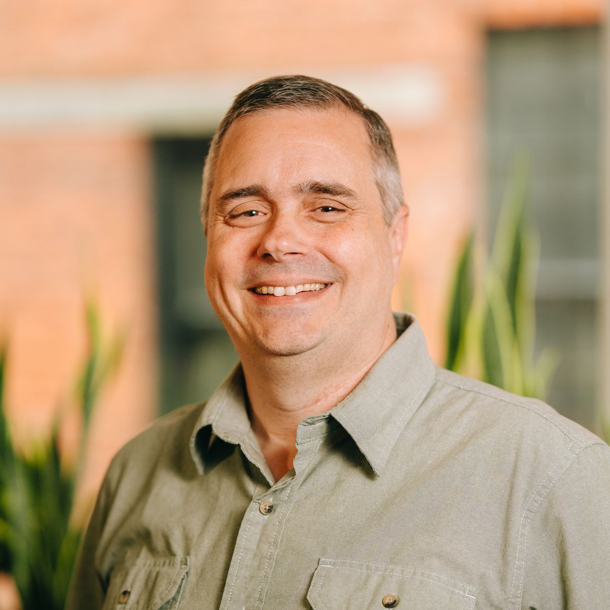 Ross Winston, ACV's Chief Technology Officer, smiles at the camera in a white button down shirt and black blazer.