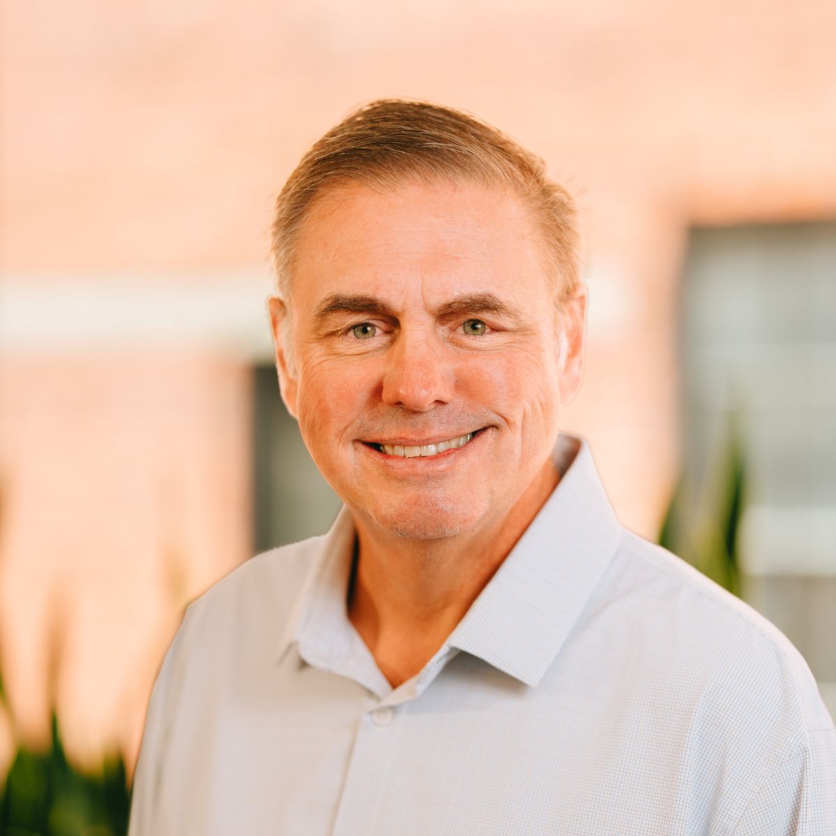 Tim Fox, ACV's Chief Financial Officer, smiles at the camera in a white button down shirt and black blazer.