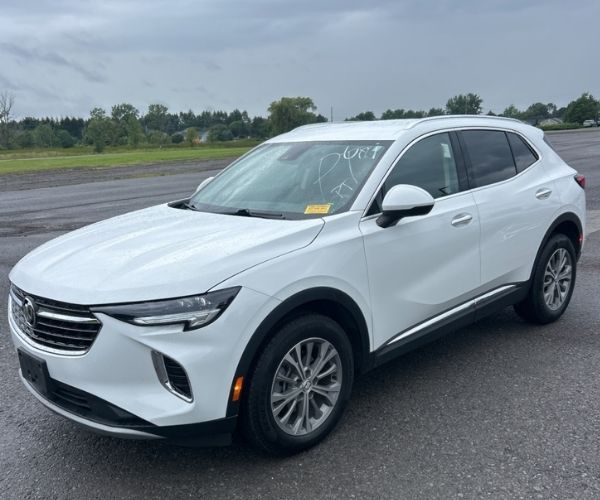 A used white 2022 Buick Envision parked in empty parking lot