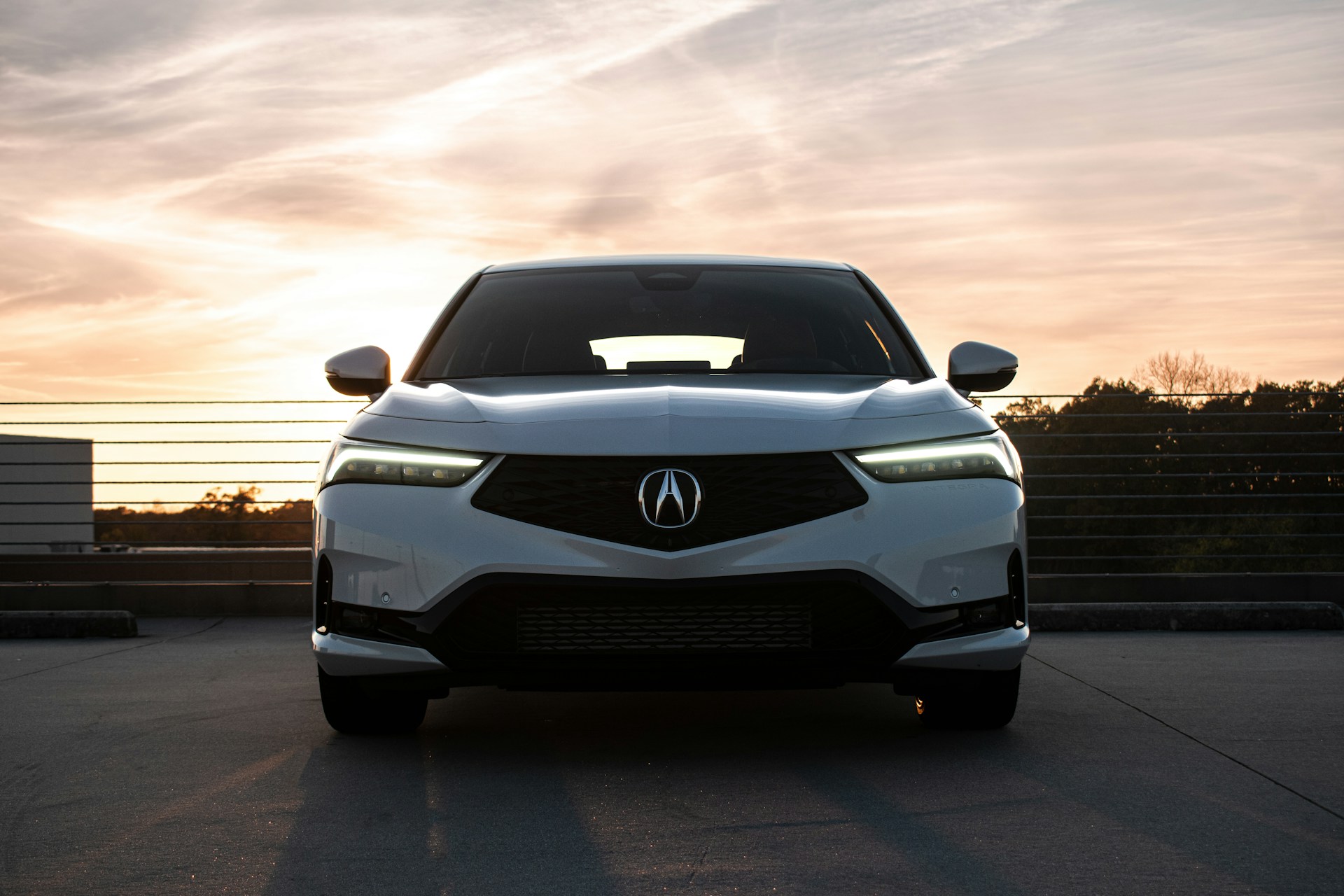 White Acura in parking garage