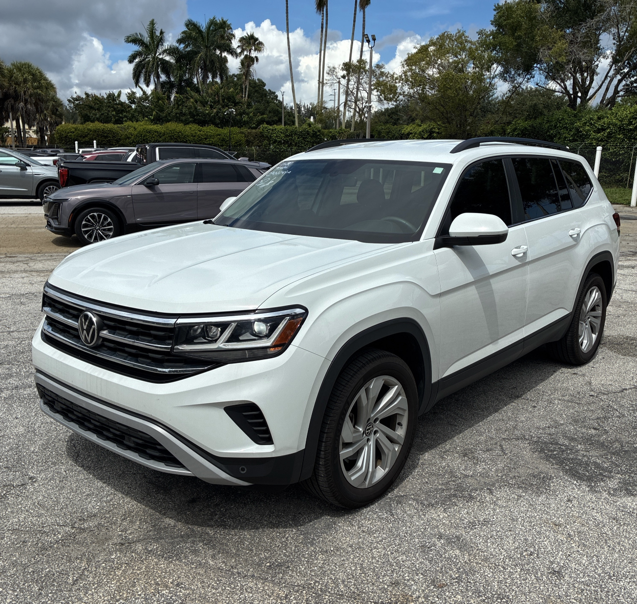 A white 2022 VW Atlas parked in a dealer lot.