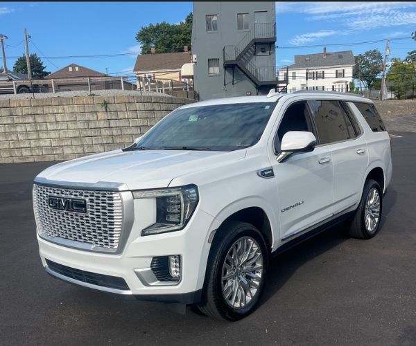 A white 2024 GMC Yukon parked in a dealer lot