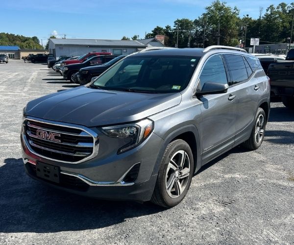 A used grey 2021 GMC Terrain in a dealer parking lot